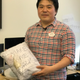Joohyung Kim holds a Baymax costume with a message from Chris Atkeson.